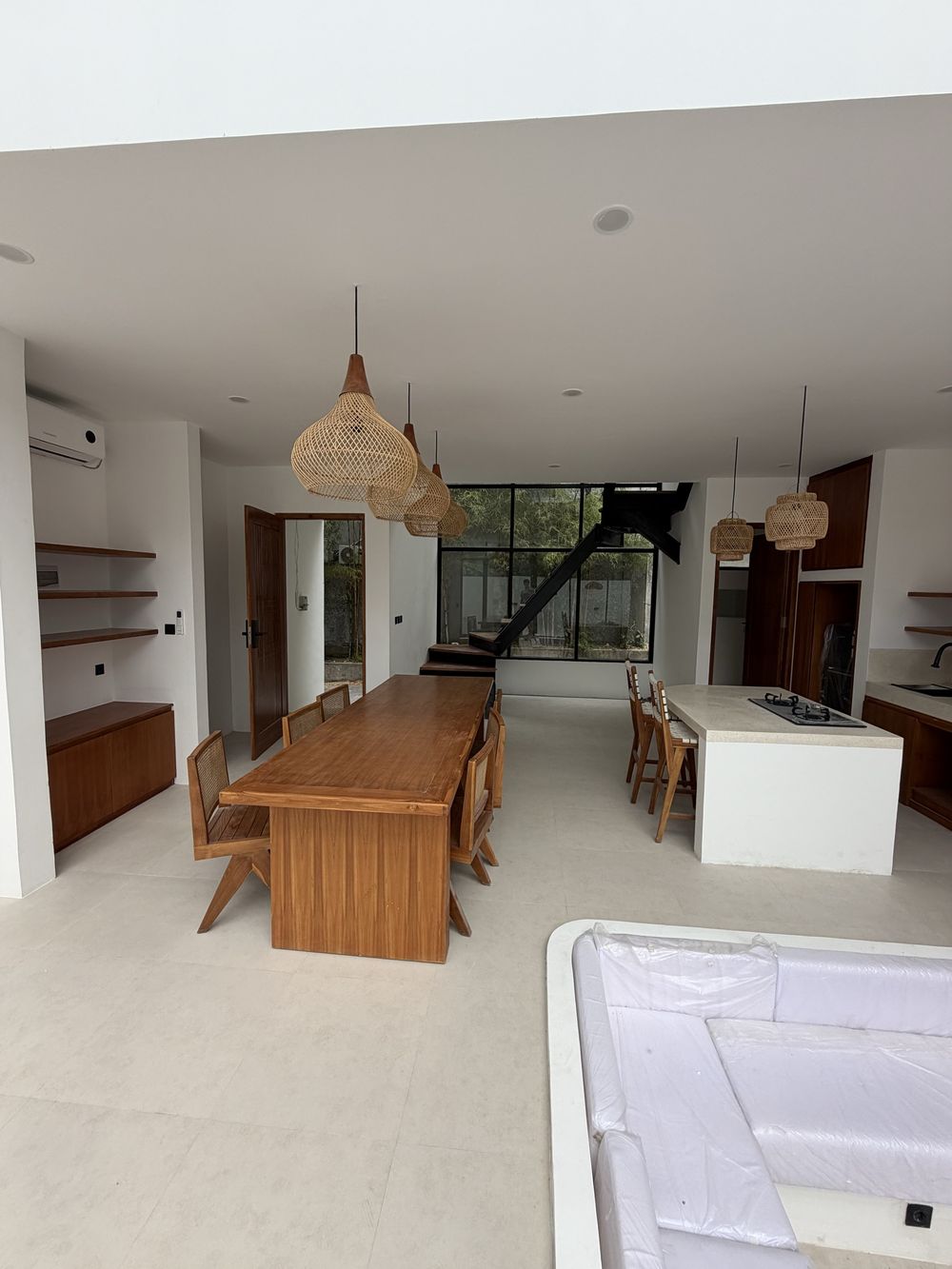 Villa 1 build progress: finished living and dining volume with furniture in place