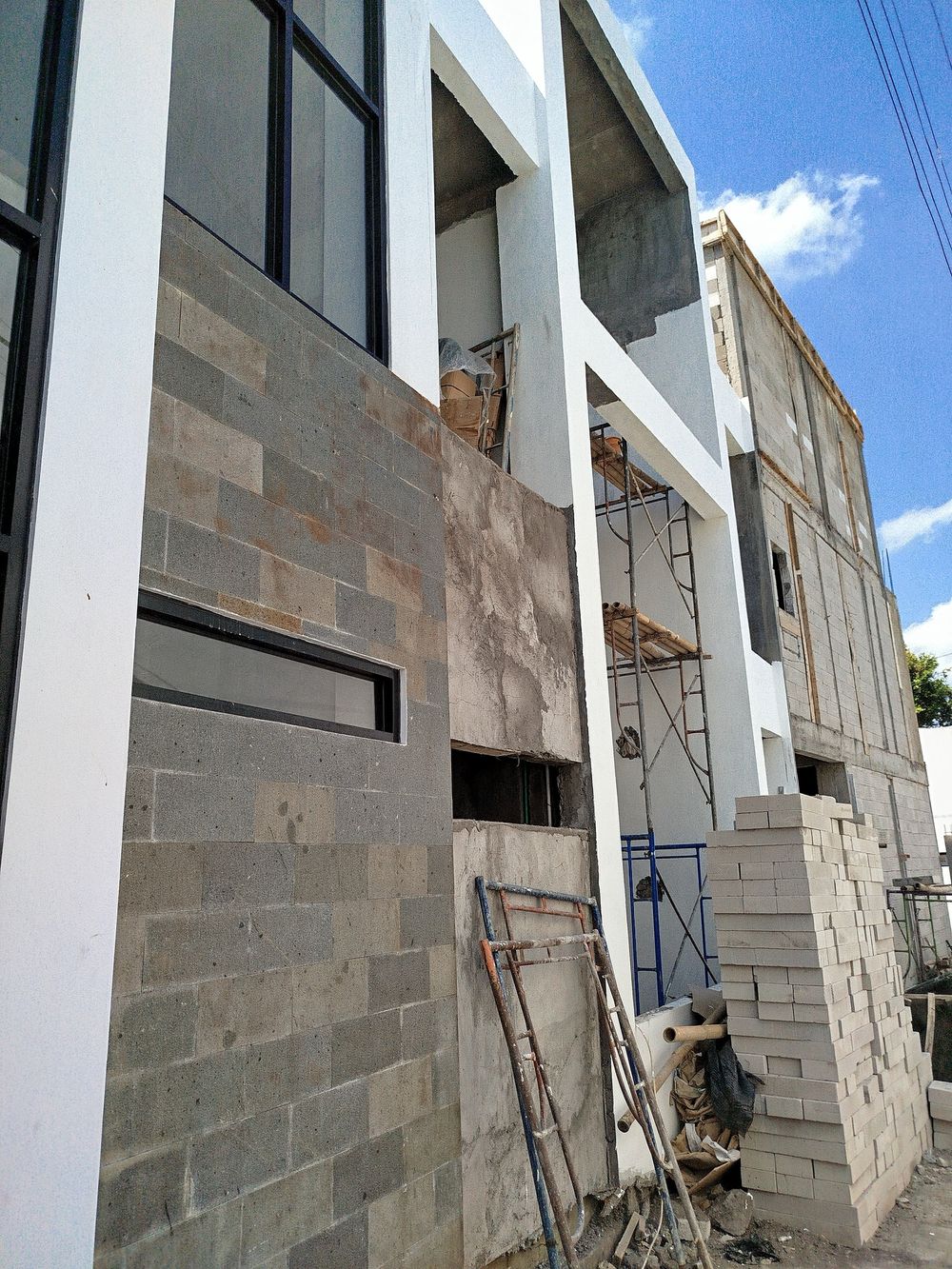 Villa 4 build progress: two-storey structure with stone cladding going onto the facade