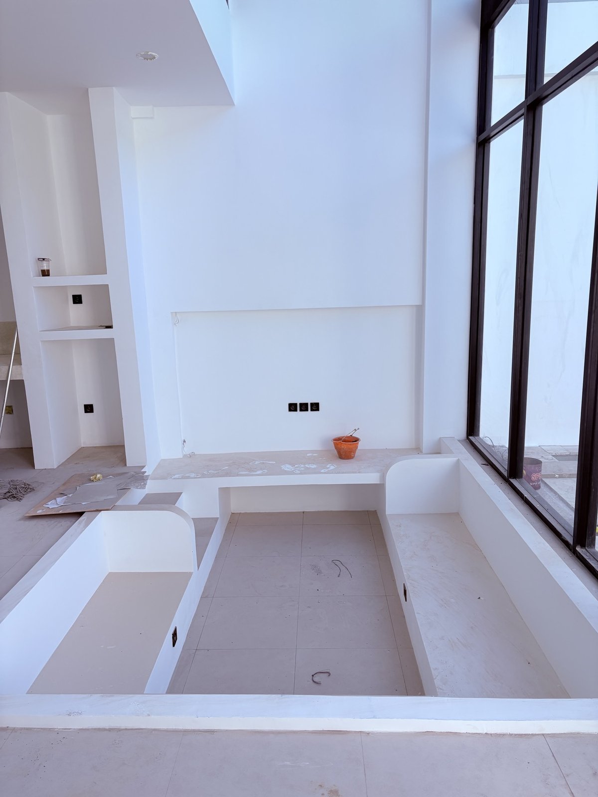 On site: double-height living volume with sunken lounge and full-height glazing